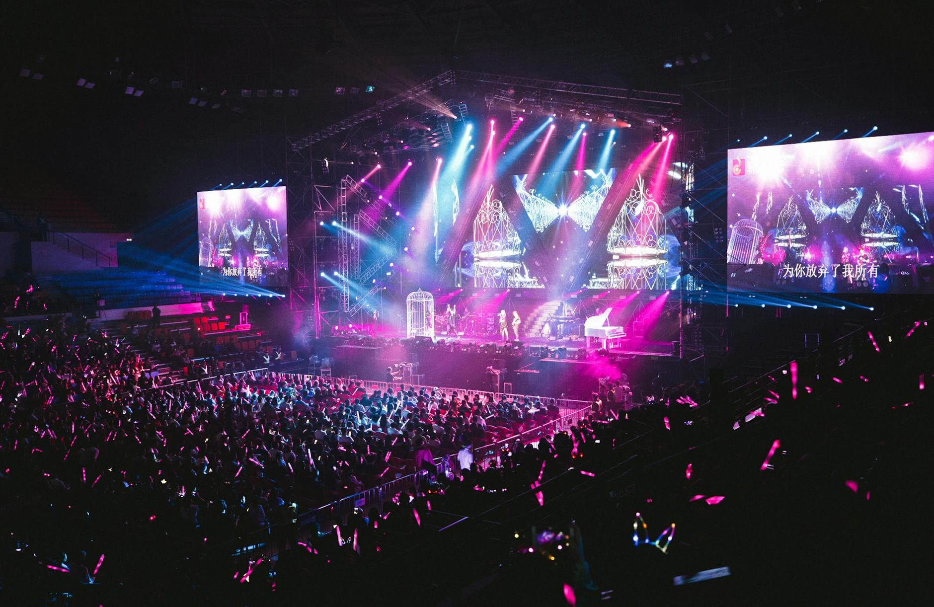 Crowd enjoying a live event with stage lights